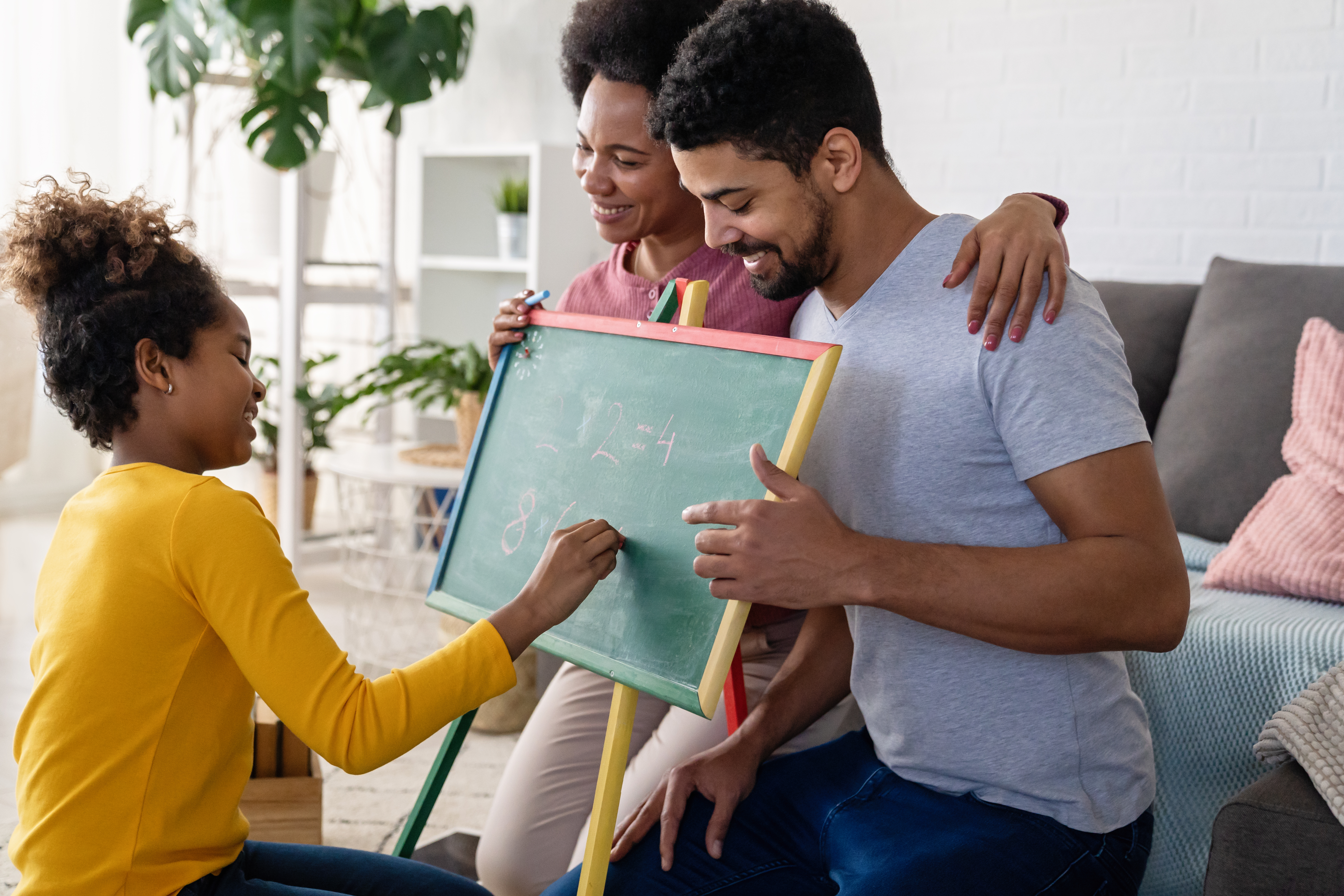 Multiethnic black diverse family teaching child. Home education family concept