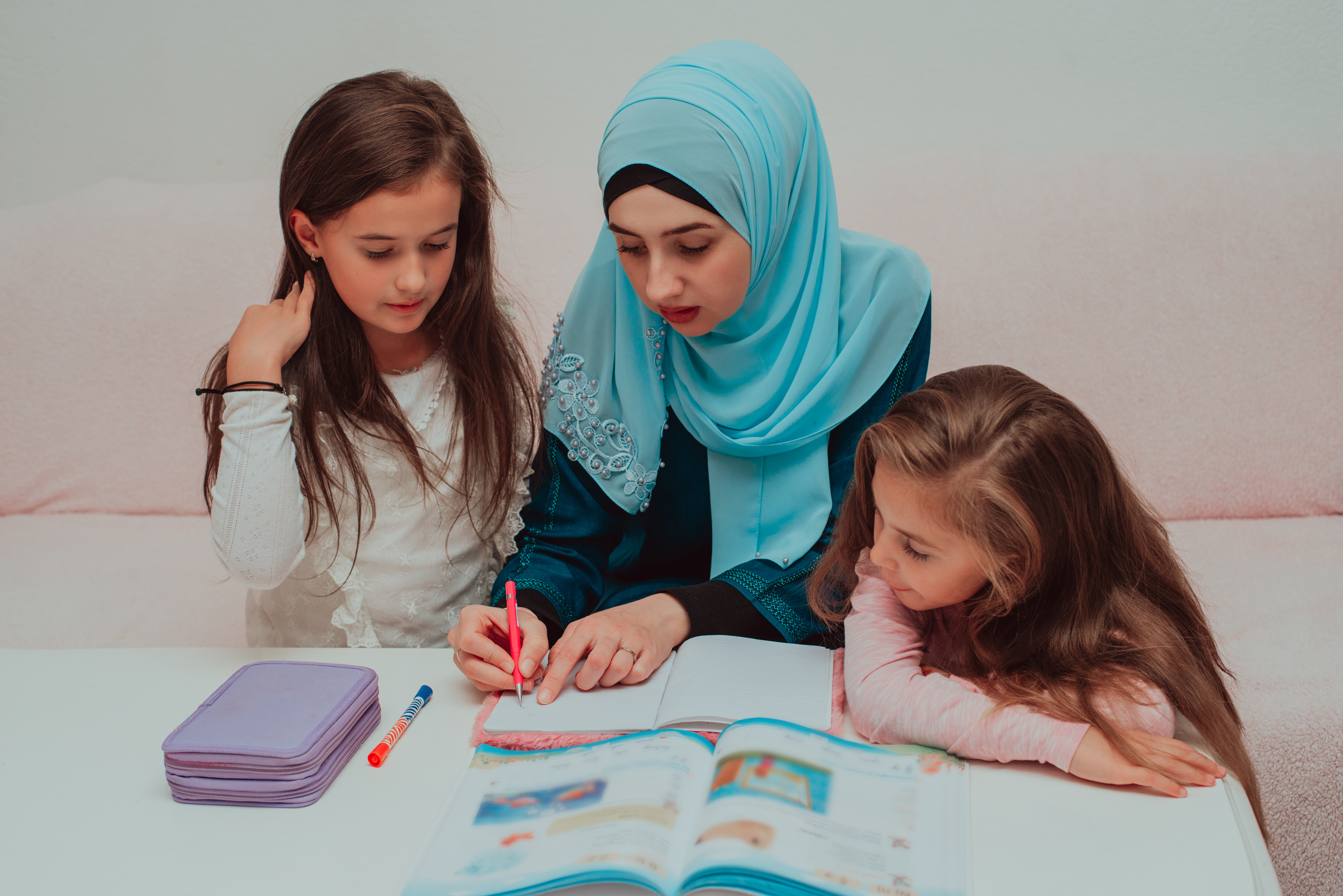 young-mother-hijab-helping-child-daughter-homework-happy-muslim-family-home